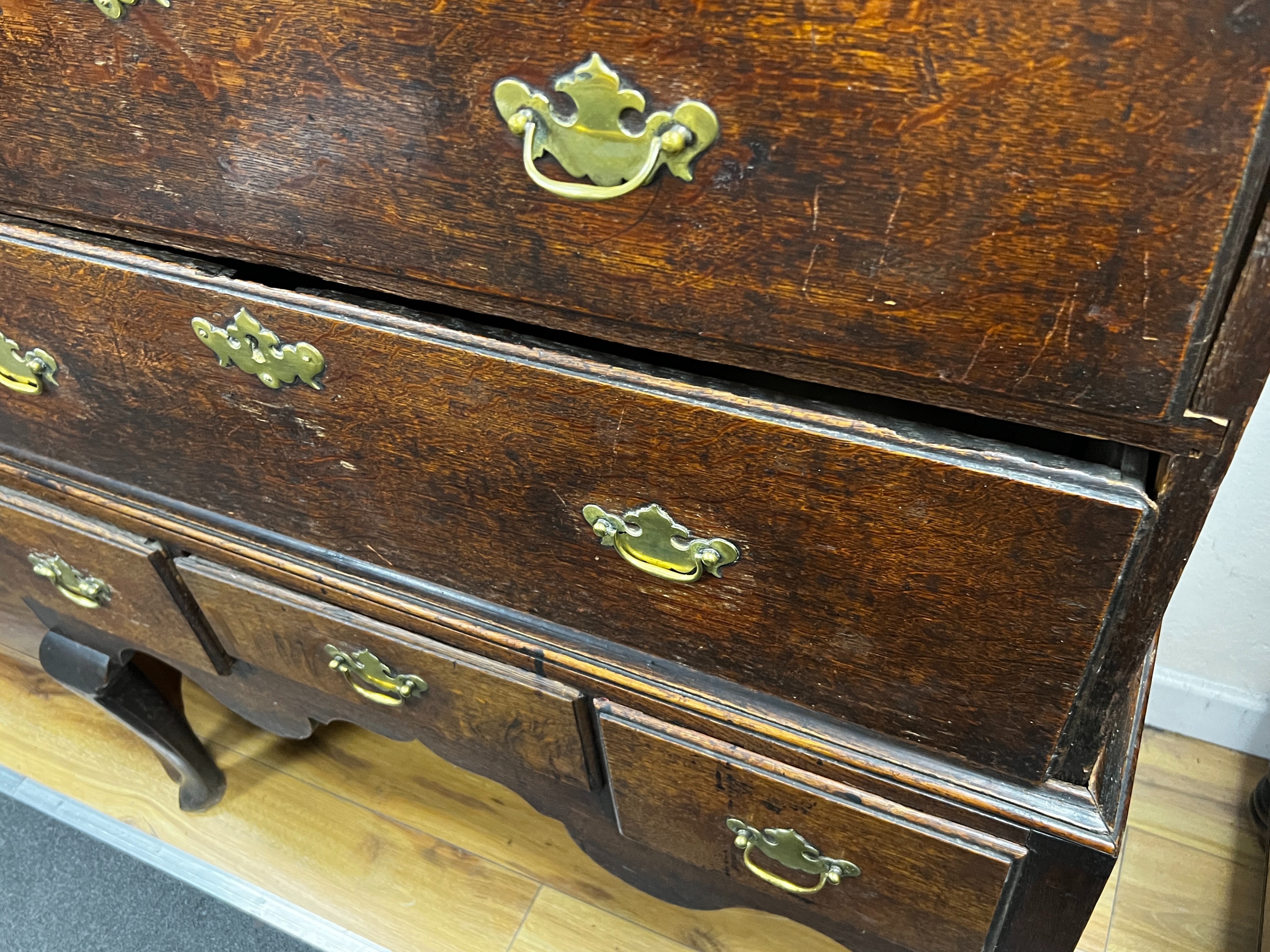 An 18th century oak chest on stand, width 99cm, depth 48cm, height 154cm